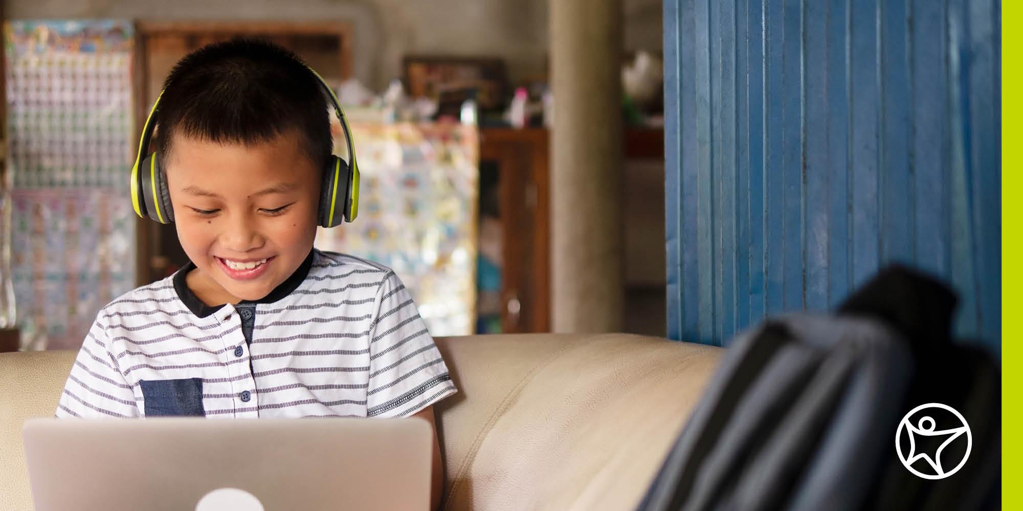 A young boy is doing his online school classwork